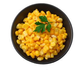 black bowl with canned corn kernels isolated on white background. top view