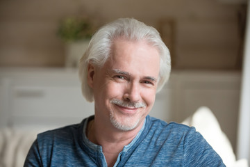 Head shot portrait of confident handsome aged man