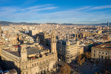 Fototapeta na wymiar Aerial; drone view of old spanish buildings in Barcelona illuminated by warm morning light; old roofs of low houses in Barcelonetta area; Sunny day in touristic capital of province of Catalonia, Spain