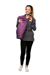 Fototapeta premium Full body Pretty woman in pajamas with headphones on isolated background