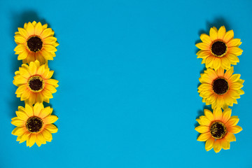 Artificial sunflowers of blue background with copy space