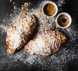 Croissants with almonds on the black background