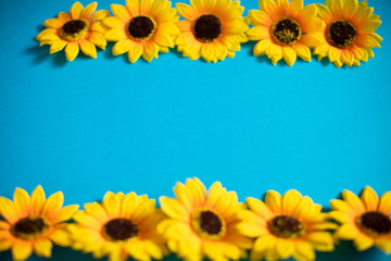 Artificial sunflowers of blue background with copy space