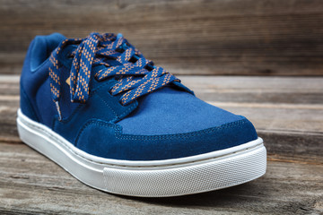 Stylish sports shoes on a wooden background
