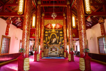 Fototapeta na wymiar Interior of Thai Northern Temple and Buddha Sculpture at Wat Phra Kaeo - Chiang Rai, Thailand