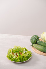 Various green organic salad ingredients on white background. Healthy lifestyle or detox diet food concept