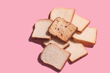 Sliced bread to toast isolated on pink background. Close up. Top view