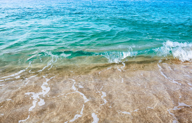 Background texture of close up crystal clear, turquoise waves of the tropical Caribbean Sea.
