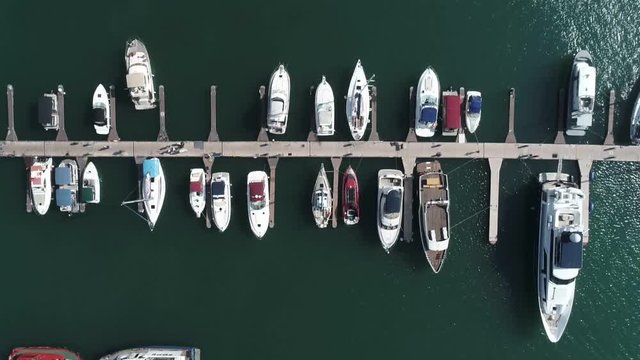Commercial sea port of Sochi. Aerial photography with quadrocopter. Yachts, sea, people, cars in motion. Clouds are flying over the building.The landmark of the city of Sochi.