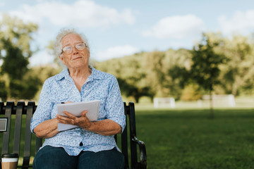 Senior woman writing down her memories into a notebook