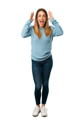 Obraz premium Full body of Blonde woman with blue shirt with surprise and shocked facial expression on white background