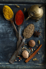 Assorted spices on the dark metal tray