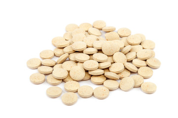 Tablets nutritional supplements vitamins on white background.