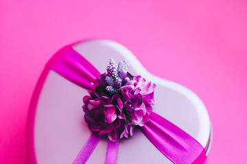 Heart-shaped gift box decorated with flower and ribbons