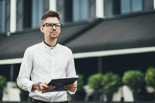 My plan must succeed. Business man in street holding document and thinking