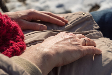 Detailed closeup of senior woman hands on winter