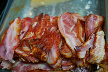 Delicious baked crispy bacon slices with pork belly fat and skin crispy  beautiful color close up unhealthy food 