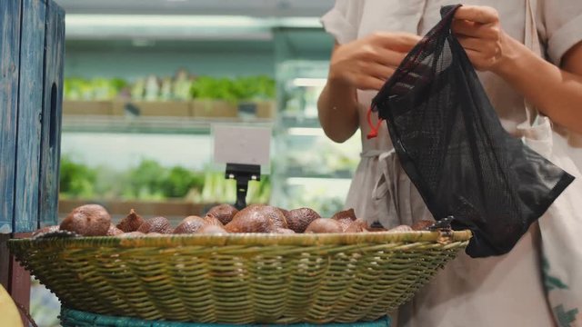 Zero Waste Concept: Young Woman Buying Fruits in Supermarket. No Plastic Bags, Healthy Vegan Lifestyle Footage. 4K. Bali, Indonesia.