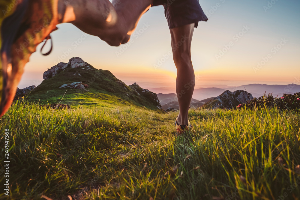 Wall mural man trail running on a mountain at the dask