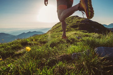 Man trail running on a mountain at the dask