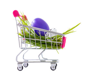Easter eggs in a shopping cart, seasonal sale concept on white for stores