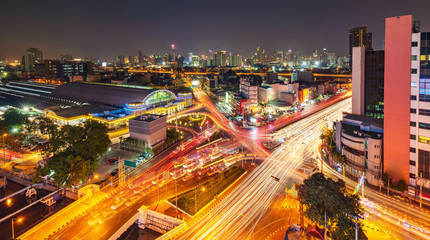 Fototapeta na wymiar Modern city night background, The light trails on the modern building in Bangkok thailand