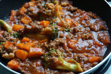 Delicious pasta with tomato sauce seafood mince cucumber lettuce on white plate Italian spaghetti with potato and carrots broccoli close up Western cuisine traditional food 