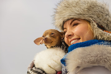 Woman hug warming her dog in cold day