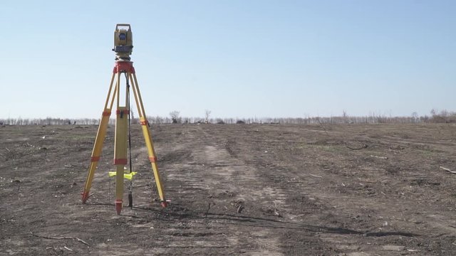 Industrial equipment, total station on the field, sunny autumn day