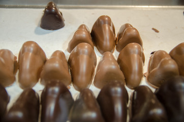 Dark and milk chocolate noses on the shop window. Chocolate figures