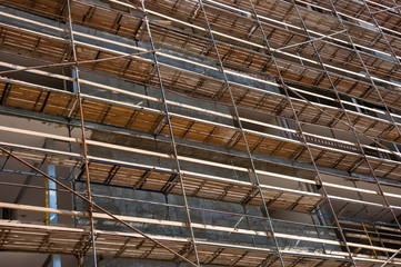 Scaffolding at the construction site of a new building. Construction site background.