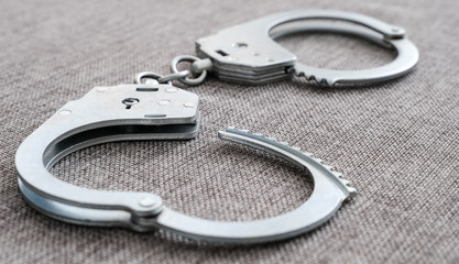 The cuffs on the table. Police unit. Close-up top view selective focus.