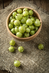 Fresh gooseberry in a wooden bowl.