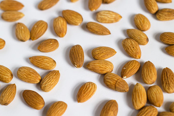 handful of almonds on white background