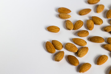 handful of almonds on white background