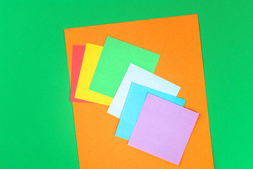 DIY rainbow colored paper, cotton wool cloud St Patricks Day green background.