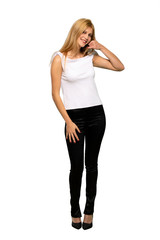 Fototapeta premium Young blonde woman making phone gesture. Call me back sign over isolated white background