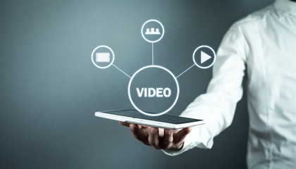 Man holding tablet with Video sign. Video marketin