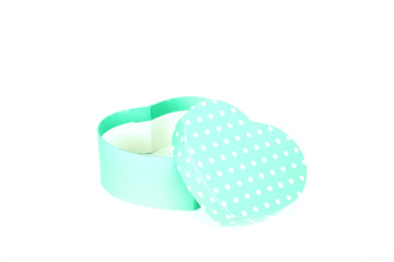 green gift box with white polka dots and heart shape on white background 