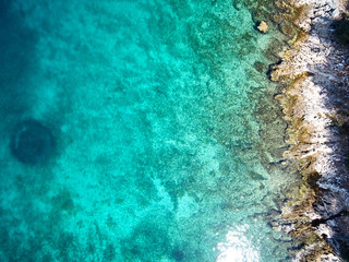 Fototapeta na wymiar top view of rocky shore crystal clear Adriatic Sea, drone shot
