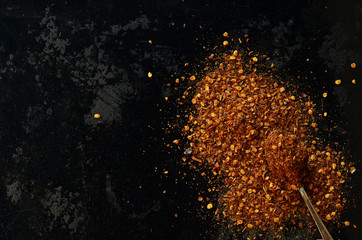 Dried chilli powder on a black background