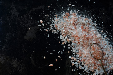Rock salt scattered on a black background