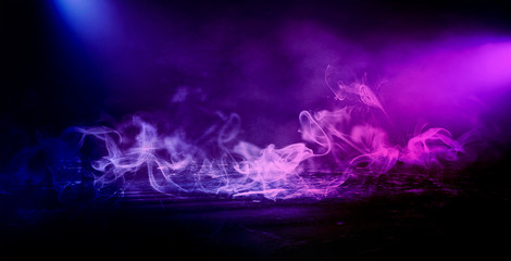 Fototapeta premium Background of an empty dark room. Empty walls, neon light, smoke, smog. Blue and pink smoke, ultraviolet light in the dark.