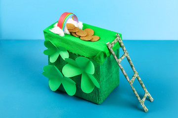 DIY leprechaun trap with gold coins,  rainbow and green ladder St Patricks Day background.