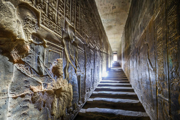 DENDERA TEMPLE, QENA, EGYPT - DECEMBER 05, 2018: Corridors with ancient hieroglyphs and reliefs in...