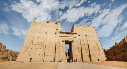 Naklejka premium The main entrance of Edfu Temple showing the first pylon, Dedicated to the Falcon God Horus, Located on the west bank of the Nile, Edfu, Upper Egypt