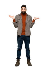 Full-length shot of Handsome man with beard having doubts while raising hands and shoulders on isolated white background