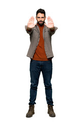 Full-length shot of Handsome man with beard making stop gesture for disappointed with an opinion on isolated white background
