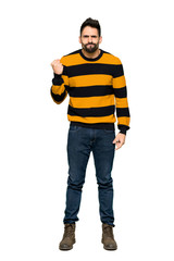 Fototapeta premium Full-length shot of Handsome man with striped sweater with angry gesture on isolated white background