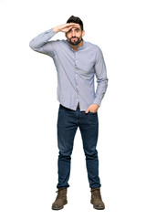 Naklejka premium Full-length shot of Elegant man with shirt looking far away with hand to look something on isolated white background